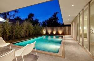 Landscape-lighting-against-a-backyard-fence